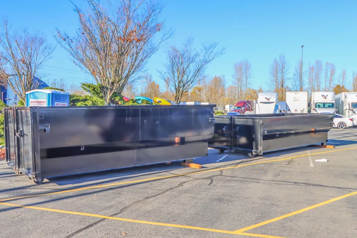 Professional dumpster rental service with roll-off container on residential driveway in Old Orchard Beach